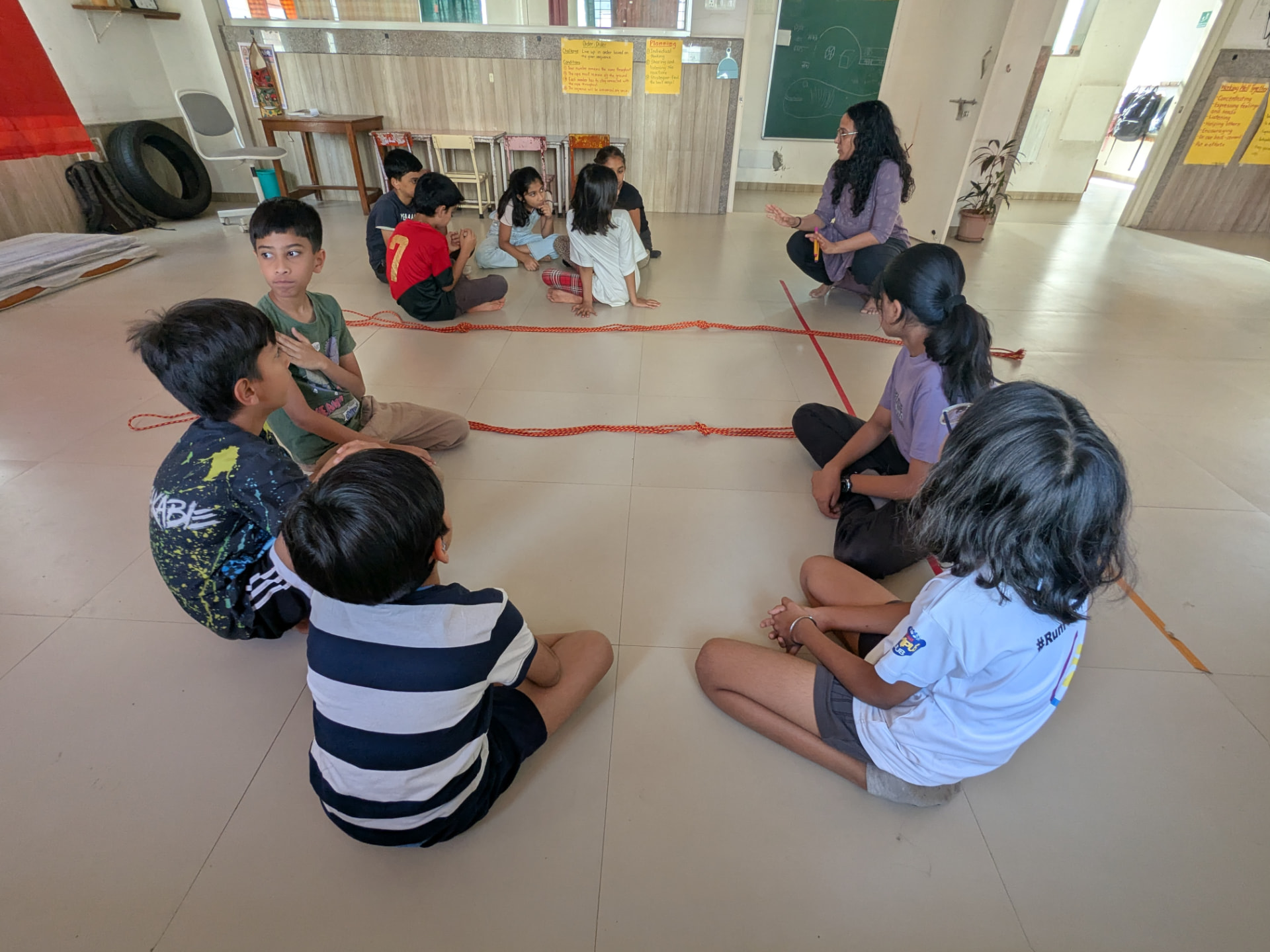 Nisha facilitating a learning session with a group of children